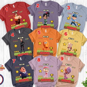 May include: Nine different t-shirts featuring various cartoon characters from Disney Pixar movies. The shirts are in different colors, including red, purple, blue, gray, orange, and pink. Each shirt has a different character, including a character from the movie 'Inside Out', 'Big Hero 6', 'The Incredibles', and 'Toy Story'.