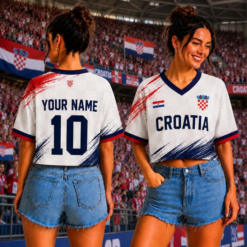 May include: A white cropped V-neck jersey with navy blue and red brushstroke accents. The front features the text CROATIA, a small Croatian flag, and a crest. The back displays the text YOUR NAME and the number 10 in navy blue lettering.
