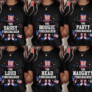 May include: A black t-shirt featuring a graphic of a red, white, and blue top hat, fireworks, and shoes. The text reads THE SASSY, BOUGIE, PARTY, LOUD, HEAD, or NAUGHTY FIRECRACKER. Each design includes a small American flag and patriotic star accents.