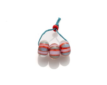 three pink, red and turquoise striped beads