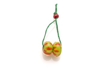 pair of green and red spotted beads