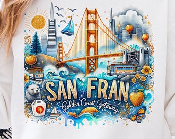 Puede incluir: Una camiseta blanca con una ilustración colorida del Puente Golden Gate, un tranvía y otros monumentos de San Francisco. El texto "San Fran Golden Coast Getaway" está impreso en la camiseta.