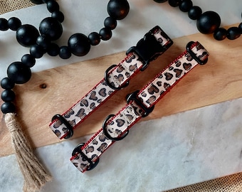 May include: Two red and beige leopard print dog collars with black metal hardware.