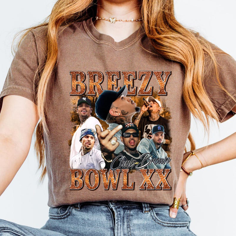 A woman wearing a brown t-shirt with a graphic design featuring the text "BREZZY BOWL XXX" and multiple images of people.