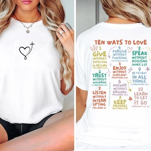 May include: White t-shirt with a heart and cross design on the front and a graphic on the back that says "Ten Ways to Love" with ten different ways to love listed with bible verses.