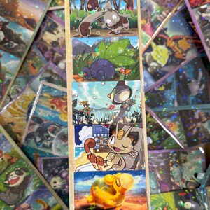 May include: A rectangular bookmark featuring five stacked, holographic illustrations of various cartoon creatures in outdoor settings, topped with a light blue ribbon. The artwork depicts a brown rabbit-like creature, a blue plant-like being, a hooded figure with flowers, a tan cat-like character, and a yellow creature.