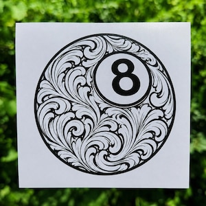 May include: A square white sticker featuring a circular black and white graphic of a billiard ball. The design includes a central number eight inside a white circle, surrounded by intricate black swirling leaf patterns on a white background.