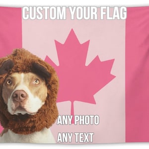 May include: Pink tapestry featuring a Canadian flag design and a dog wearing a brown lion's mane. Text on the tapestry reads "CUSTOM YOUR FLAG" and "ANY PHOTO ANY TEXT". The dog has brown and white fur.
