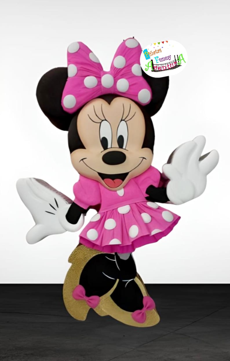 May include: A pink and white polka dot Minnie Mouse pinata with a black bow and black shoes. The pinata is standing on a white surface. The text "Minnie's Funny Birthday" is on a white circle with a colourful border.