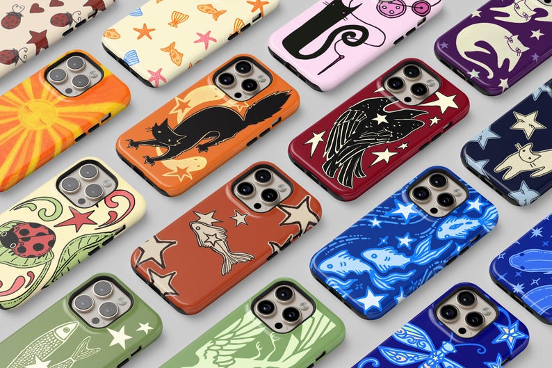 May include: A collection of smartphone cases featuring diverse graphic patterns including ladybirds, cats, fish, stars, and celestial motifs in various colours such as orange, red, blue, green, and purple, each with a triple camera lens cutout.