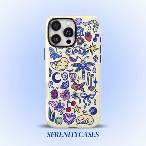 May include: A cream-colored phone case featuring a dense pattern of colorful illustrations including a dragonfly, butterfly, duck, fish, ladybug, flowers, cherries, a key, a bow, an eight ball, and stars. The text SERENITYCASES appears at the bottom.