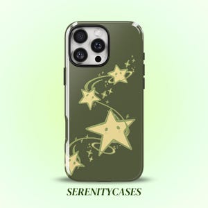 May include: An olive green smartphone case featuring a graphic of pale yellow stars with small facial features. The stars are arranged in a swirling pattern with thin, curved lines connecting them. The text SERENITYCASES is printed at the bottom.
