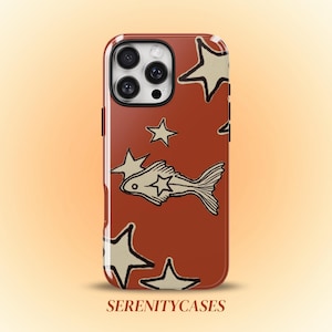 May include: A rust-colored phone case featuring a repeating pattern of cream-colored stars and a central fish illustration with a star on its side. The text SERENITYCASES is printed in a brown serif font at the bottom of the phone case design.