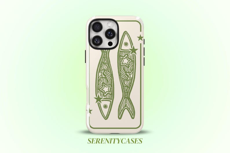 May include: A phone case with a cream-colored background featuring two olive green fish illustrations decorated with wavy lines and star shapes. The design is enclosed in a thin olive green rectangular border. The text SERENITYCASES appears below.
