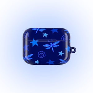 May include: A navy blue AirPod case featuring a pattern of blue dragonflies, stars, and swirls. The case has a small loop on the side for attaching to a keychain or lanyard. The design is repeated across the surface.