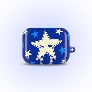 May include: A navy blue AirPod case featuring a large, off-white star with a face, surrounded by smaller white and blue stars. The case has a rounded rectangular shape with a small loop on the side.