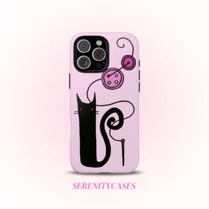 May include: A light pink phone case featuring a black cat illustration with a needle and thread design. The case also has pink button graphics and the text "SERENITYCASES" at the bottom.