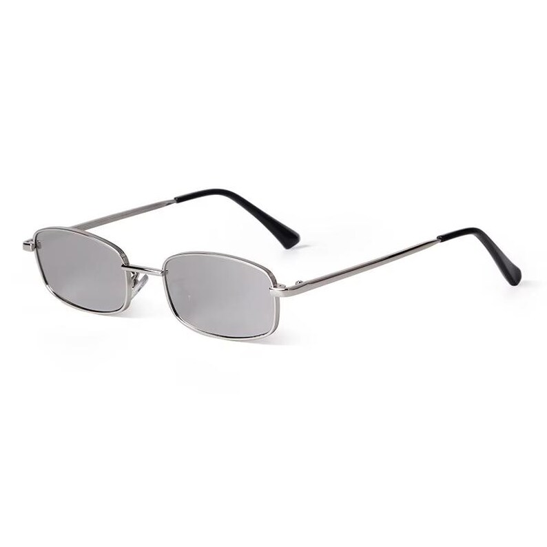 May include: Silver-framed sunglasses with rectangular lenses and black temples. The sunglasses have a sleek, minimalist design, suitable for various styles. The lenses appear to be a reflective, mirrored color.