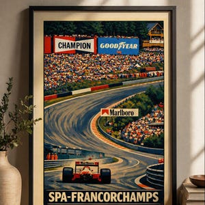 May include: Framed vintage racing poster featuring a Formula 1 car speeding on a track. The poster includes the text "SPA-FRANCORCHAMPS", "CHAMPION", "GOOD YEAR", and "Marlboro". The artwork has a retro style with a crowd of spectators.