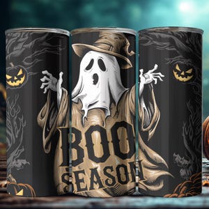 May include: Three black and white Halloween themed tumblers with a ghost wearing a witch's hat and the text "BOO SEASON".