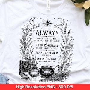 May include: A white t-shirt featuring a black graphic print of a crescent moon, a star, and botanical elements surrounding the text: ALWAYS THROW SPILLED SALT OVER YOUR LEFT SHOULDER, KEEP ROSEMARY BY YOUR GARDEN GATE, PLANT LAVENDER FOR LUCK, AND FALL IN LOVE WHENEVER YOU CAN. Below the text are illustrations of a book, a jar, a cauldron, and a candle.