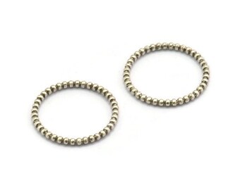 May include: Two silver beaded rings, each with a circular shape. The rings are made of small, evenly spaced beads.