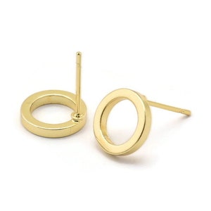 May include: A pair of gold-toned circle stud earrings. Each earring features a simple, round design with a post and a butterfly backing.