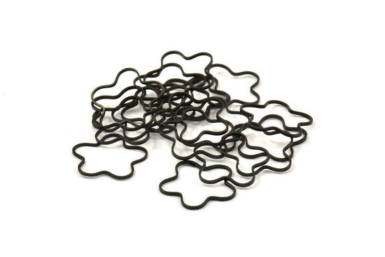 May include: A pile of black rubber hair ties shaped like flowers.
