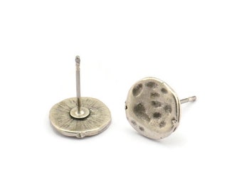 May include: A pair of silver stud earrings with a hammered texture. The earrings are round and have a post back.