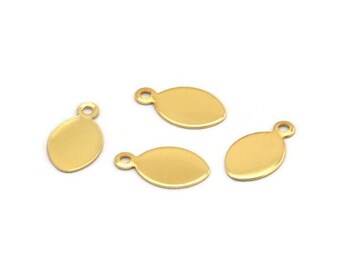 May include: Four gold-colored metal oval-shaped charms with a small loop at the top.