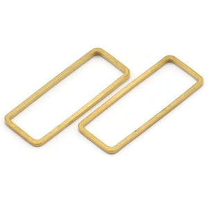 May include: Two gold-coloured rectangular metal hoops. The hoops are open and have a smooth, polished finish.