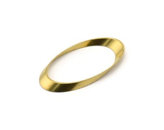 May include: A gold-colored metal ring with a slightly oval shape. The ring is smooth and has a shiny finish.