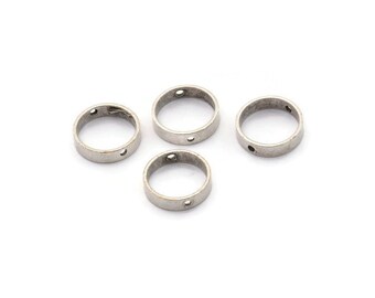 May include: Four silver jump rings with a small hole in each ring.