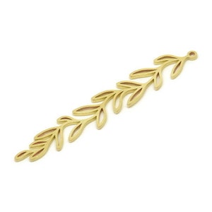 May include: A gold-coloured, leaf-shaped charm or pendant. The charm has a slender, elongated design with detailed leaf cutouts along its length. It has a small loop at the top for attachment. The charm is likely used for jewellery making or crafting.
