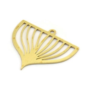 Puede incluir: Un colgante de metal dorado en forma de flor estilizada con un diseño recortado. El colgante tiene un bucle en la parte superior para sujetarlo a una cadena o cordón.