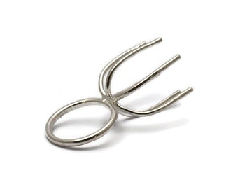May include: Silver ring setting with four prongs for a round stone.