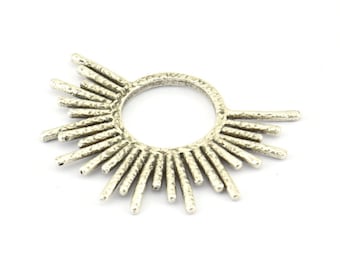 May include: Silver-toned metal ring with a textured, sunburst design. The ring has a circular shape with multiple spokes radiating outwards.