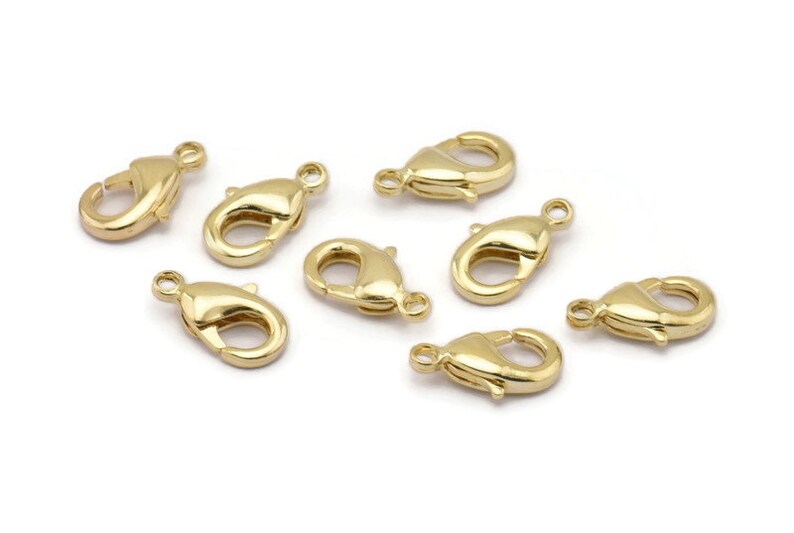Peut inclure: Huit fermoirs &agrave; ressort dor&eacute;s, un type de fermoir utilis&eacute; pour la fabrication de bijoux.