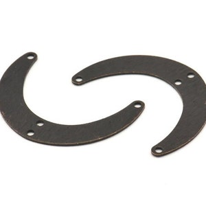 May include: Two antique bronze metal half-circle shapes with holes for attaching to a project.