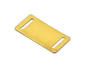 May include: A gold-colored metal tag with two slots for attaching to a collar or leash. The tag is blank and ready for engraving.