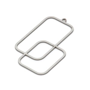 May include: A silver metal pendant with a geometric design featuring two overlapping squares. The pendant has a loop at the top for attaching to a chain or cord.