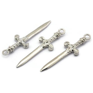 May include: Three silver sword charms with intricate details. The swords have a twisted design and a pointed tip.