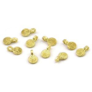 May include: Ten gold-toned metal round pendant charms with a textured surface and a small loop at the top.