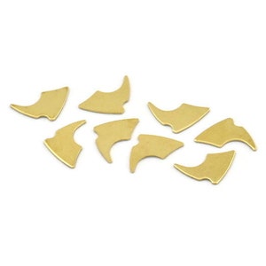 May include: A set of ten gold-coloured metal puzzle pieces shaped like a crescent moon. The pieces are scattered on a white surface.