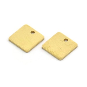May include: Two gold-colored square metal charms with a small hole in the center of each charm.