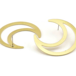 May include: A pair of gold-toned crescent moon earrings. Each earring features a double crescent moon design with a post and butterfly backing.