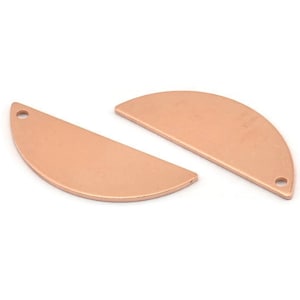May include: Two rose gold metal half circle shapes with a hole at the top. The shapes are flat and smooth.