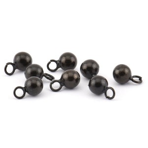 May include: Eight black metal beads with a small loop on each. The beads are round and have a smooth finish.