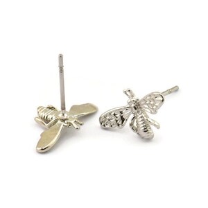 May include: A pair of silver bee stud earrings. The bees are detailed and have a delicate, intricate design.