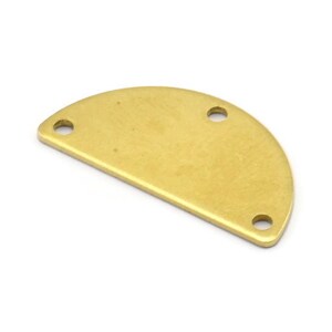 May include: A gold-colored metal half-circle charm with three holes.